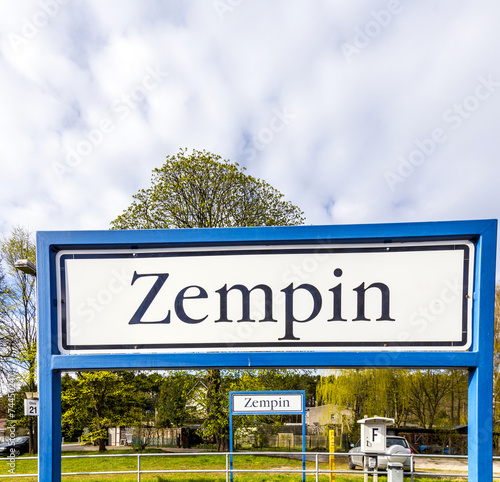 old road sign Zempin at the train station photo