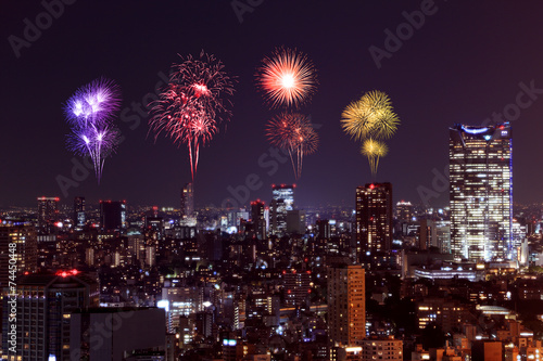 Fireworks celebrating over Tokyo cityscape at night