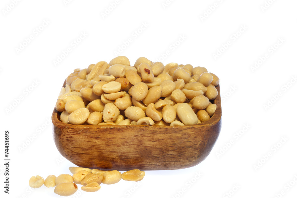 Salted, roasted, peanuts in a wooden bow, on white background Salted, roasted, peanuts in a wooden bow, on white background