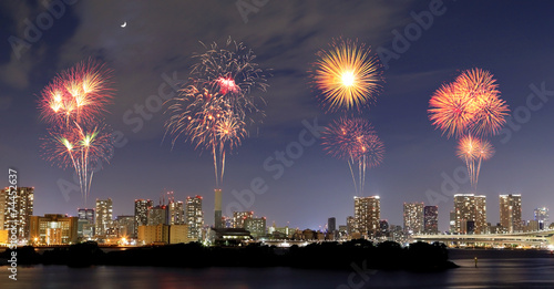 Fireworks celebrating over Odaiba, Tokyo cityscape at night
