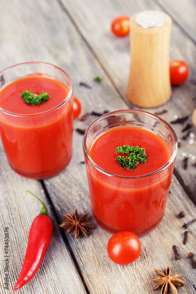 Tomato juice in glasses and fresh vegetables Tomato juice in glasses and fresh vegetables