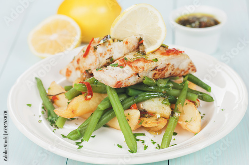 Cod fish steak with fried potato and green bean