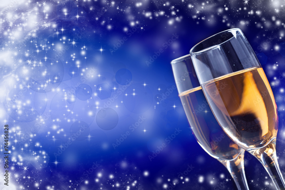 Champagne glasses against holiday lights