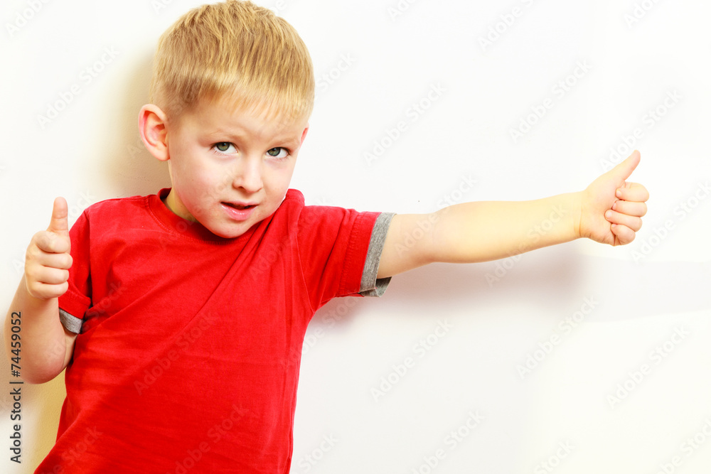 Little boy showing thumb up success hand sign gesture. Little boy showing thumb up success hand sign gesture.
