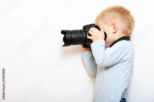  Boy child playing with camera taking photo.