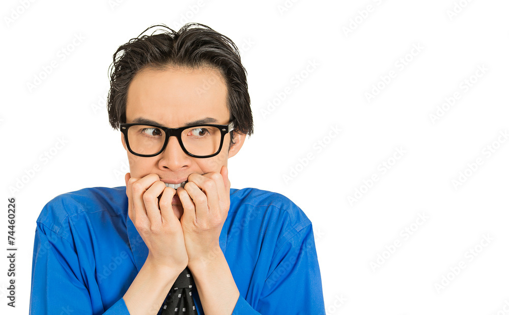 nerdy young guy with glasses biting his nails looking anxious nerdy young guy with glasses biting his nails looking anxious