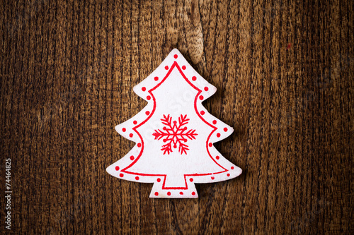 White Christmas tree ornament on wooden background