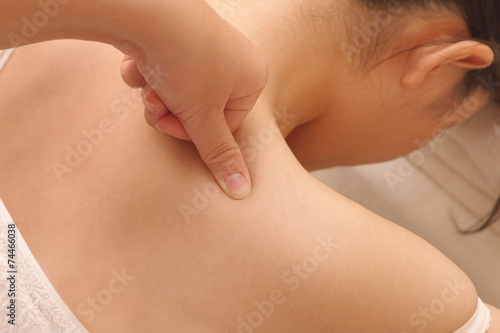 closeup asian woman having deep massage on her shoulder in spa