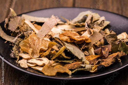 Chinese traditional herbs in the black plate.