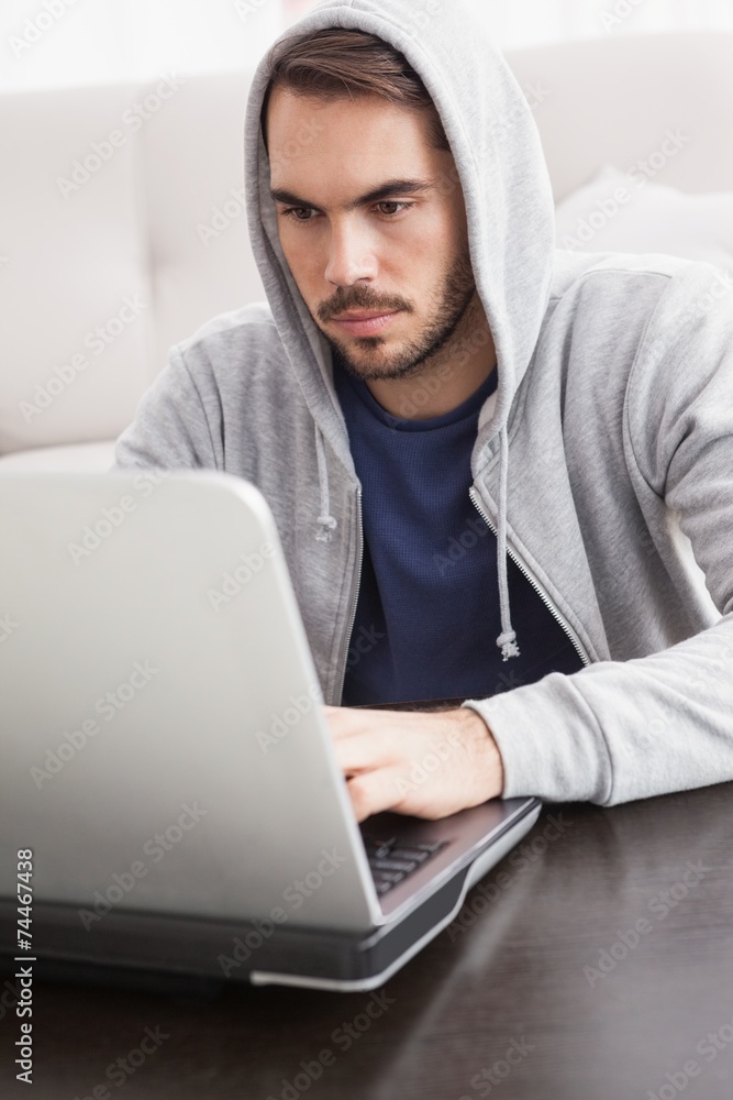 Serious young man using his laptop Serious young man using his laptop