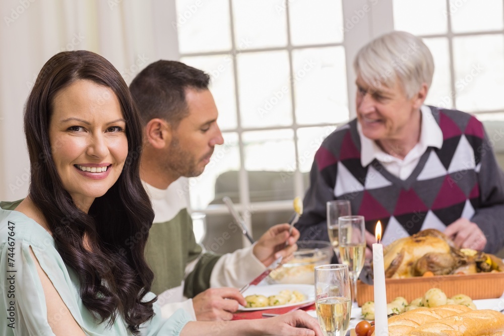 Smiling woman during christmas dinner Smiling woman during christmas dinner