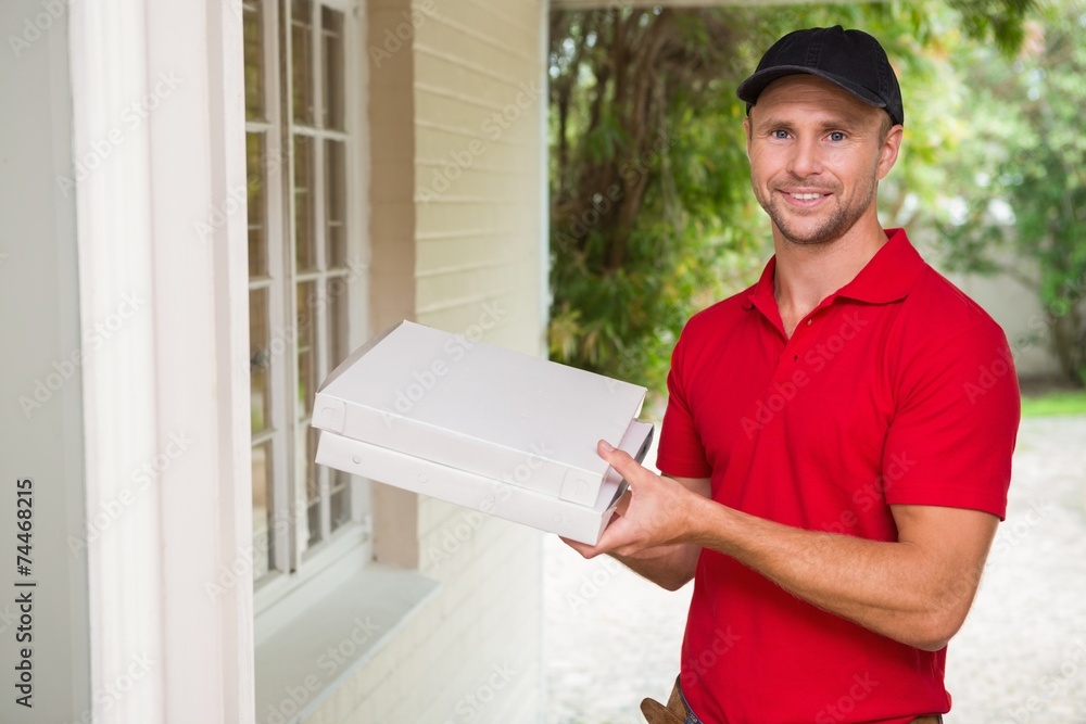 Fototapeta premium Pizza delivery man delivering pizzas