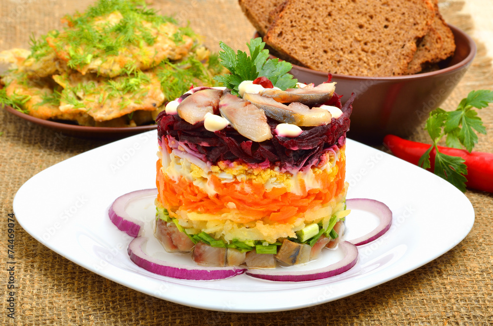 Russian traditional herring salad with beetroot, carrot, eggs on