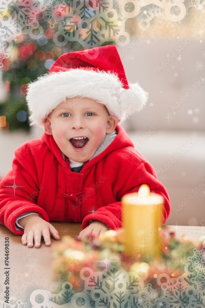 Composite image of festive little boy smiling at camera Composite image of festive little boy smiling at camera
