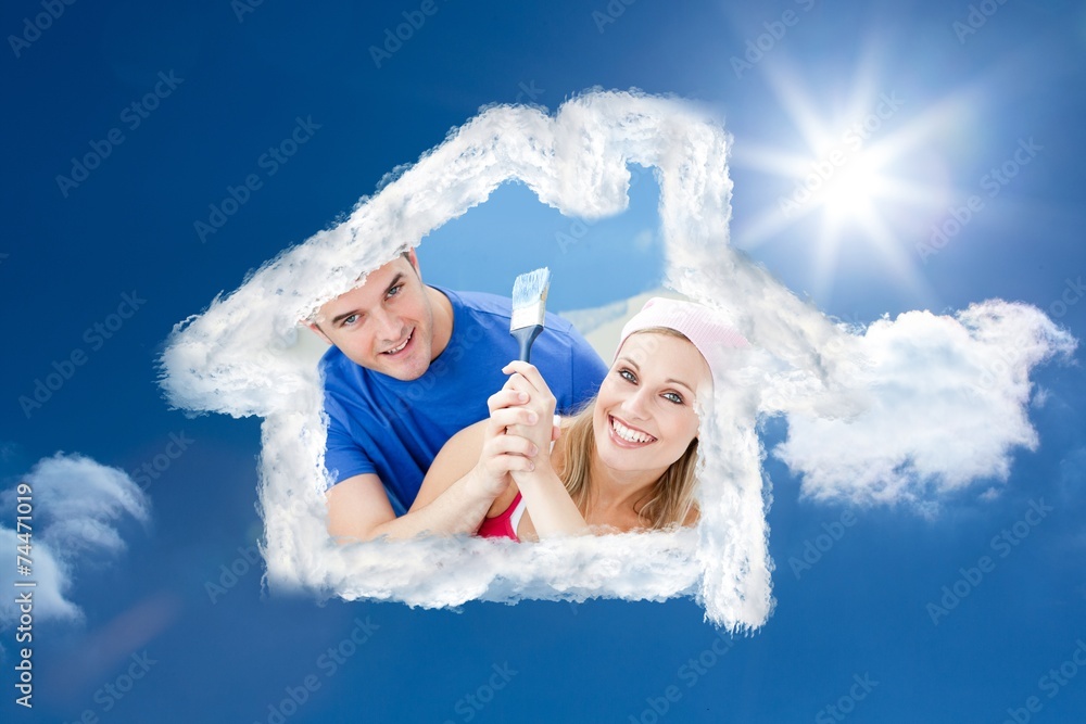Hugging couple having fun while painting a room Hugging couple having fun while painting a room