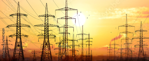 High-voltage power lines in an industrial area .On background su