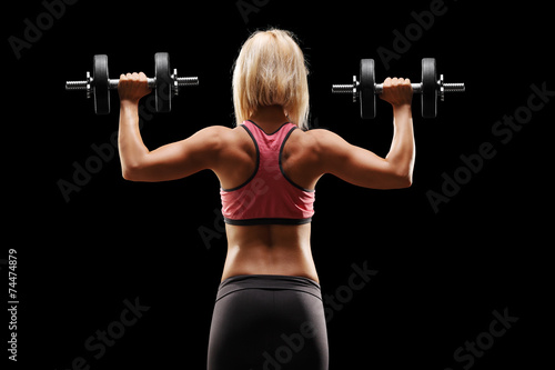 Female bodybuilder exercising with weights