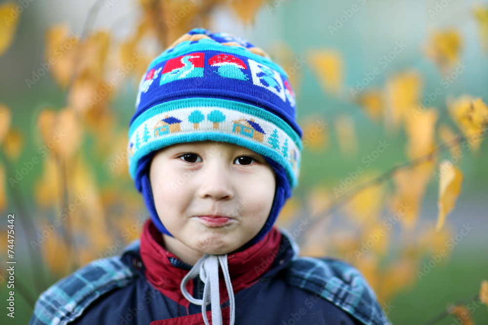 little boy in hat at fall background little boy in hat at fall background