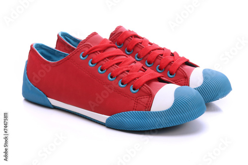 Pair of red sneakers on a white background