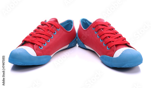 Pair of red sneakers on a w...