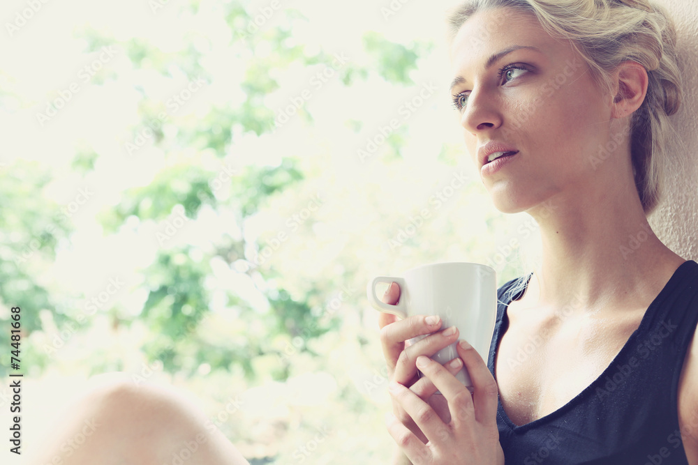Pretty woman enjoying her morning coffee