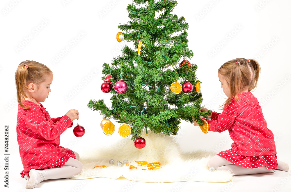 Children are decorating Christmas Tree