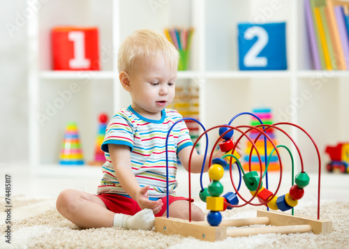 kid playing with educationa...