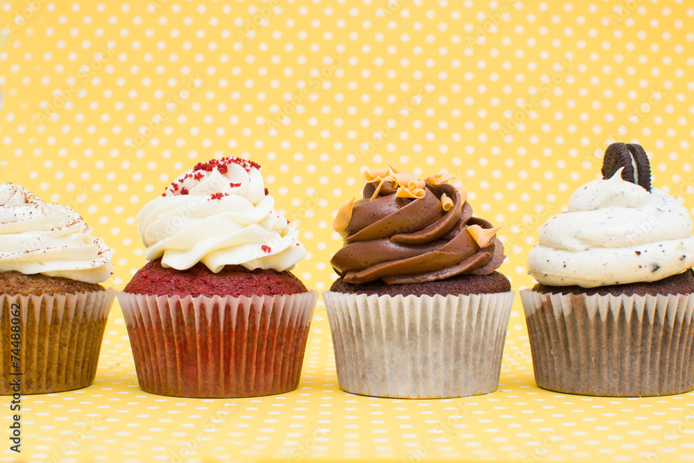 Cupcakes on yellow polka dot background