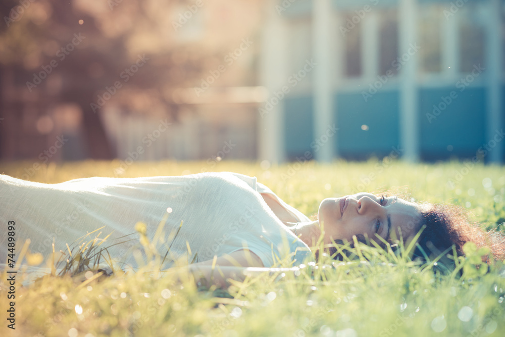 Young woman lying on grass Stock Photo | Adobe Stock