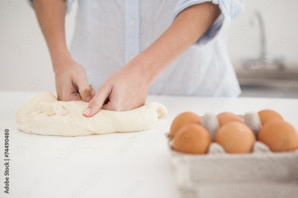 Woman kneading dough on counter Woman kneading dough on counter