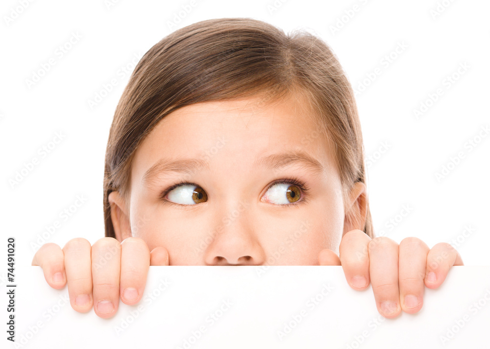 Little girl is looking from out blank board Little girl is looking from out blank board