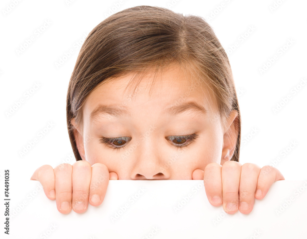 Little girl is looking from out blank board Little girl is looking from out blank board