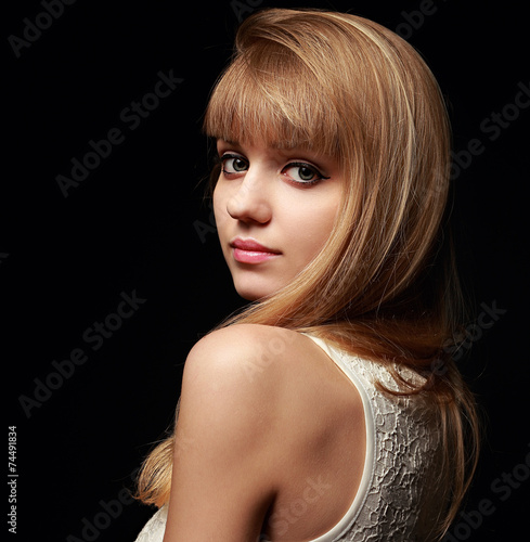 Pretty woman with blond bob hair style posing on black