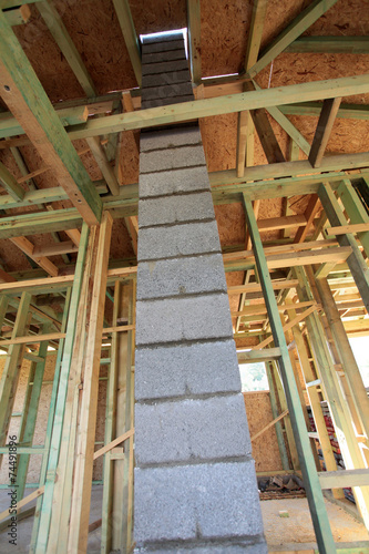 chimney of concrete blocks in unfinished wooden house