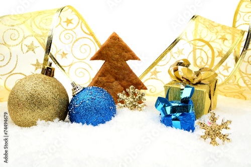 Golden and blue christmas decoration on snow with cookie tree