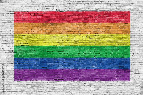 Fotobehang Rainbow flag painted over brick wall