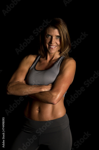 woman gray sports bra on black arms folded smile