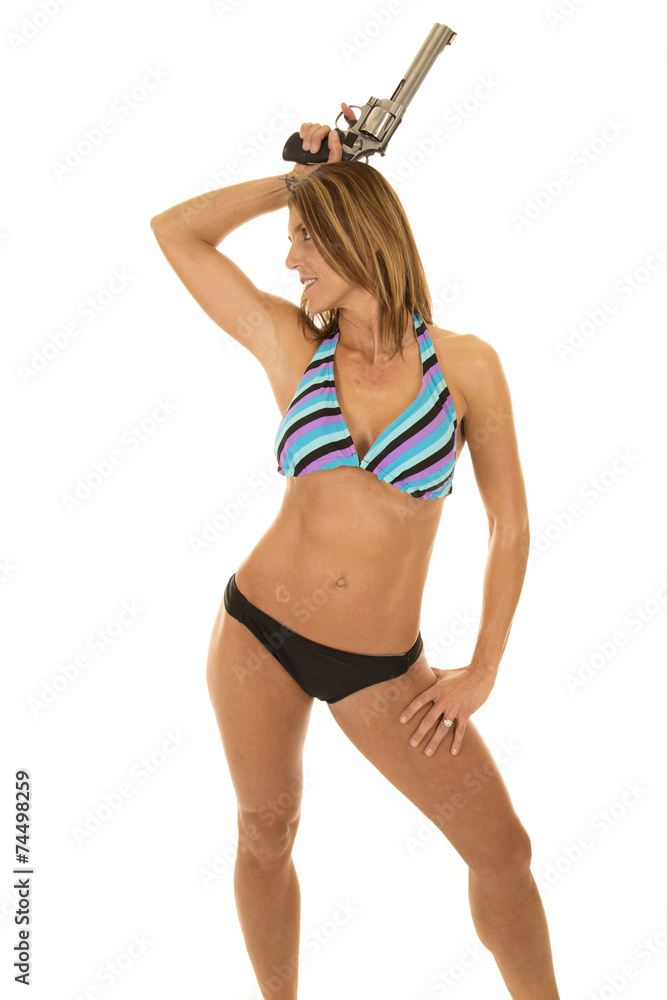 woman in a bikini with a gun over head Stock Photo | Adobe Stock