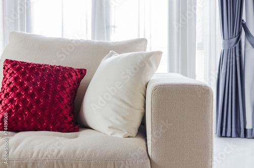 red and white pillow on white sofa