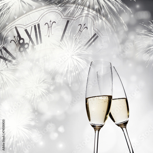 New Year's at midnight - champagne glasses and fireworks