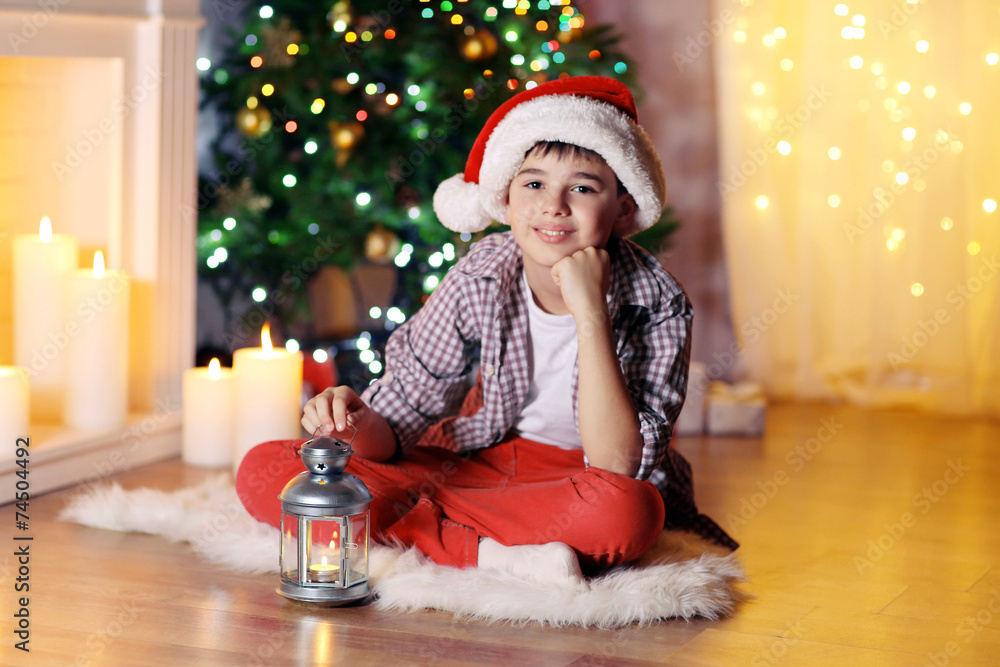Little boy sitting near fireplace in room Little boy sitting near fireplace in room