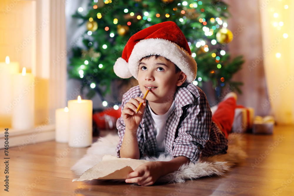 Little boy sitting near fireplace in room Little boy sitting near fireplace in room