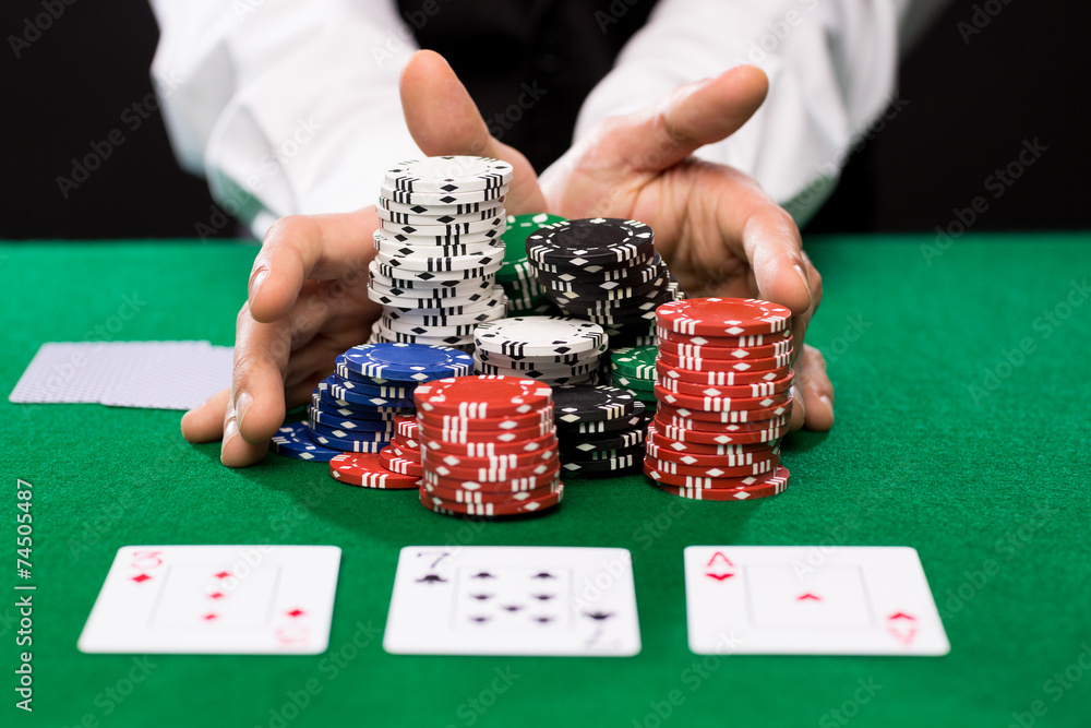 poker player with cards and chips at casino poker player with cards and chips at casino