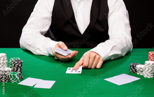 holdem dealer with playing cards and casino chips