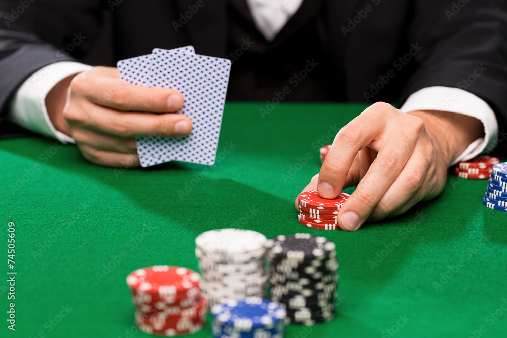 poker player with cards and chips at casino poker player with cards and chips at casino