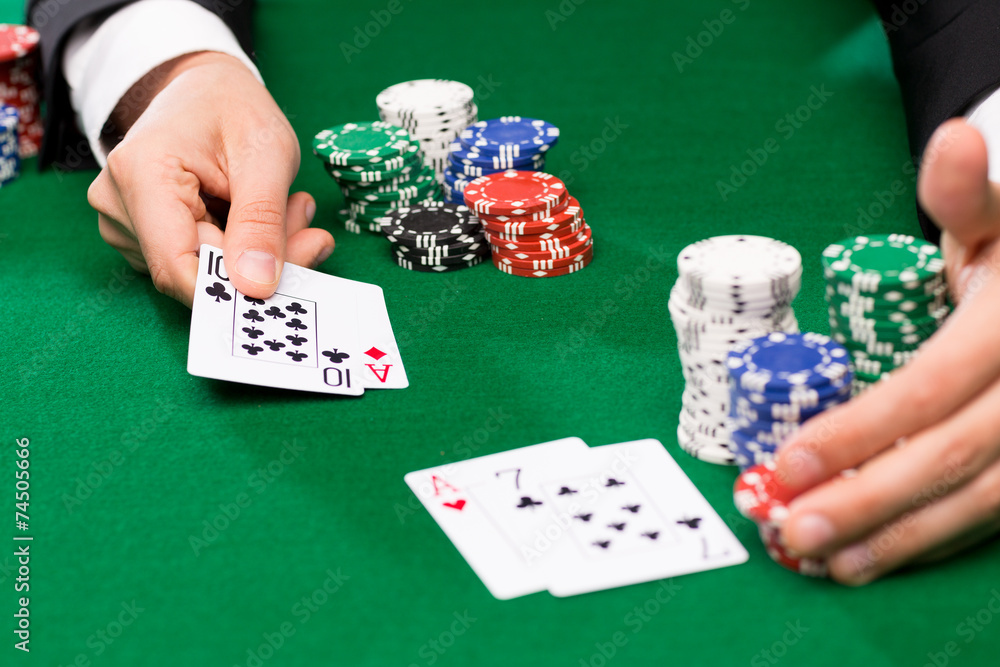 poker player with cards and chips at casino poker player with cards and chips at casino