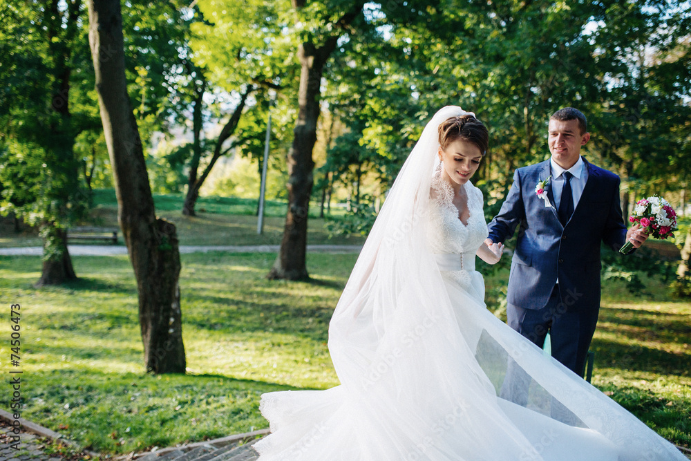 wedding couple dancing in the park on a sunny day wedding couple dancing in the park on a sunny day