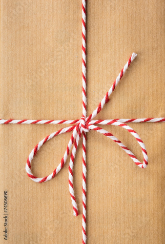 string bow against brown paper