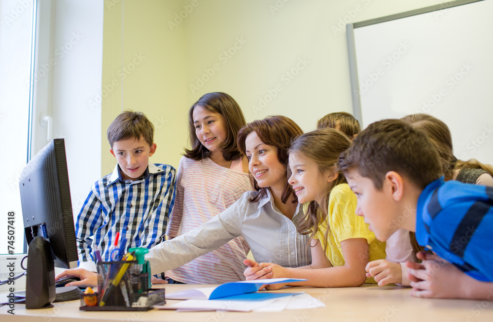 group of kids with teacher and computer at school group of kids with teacher and computer at school