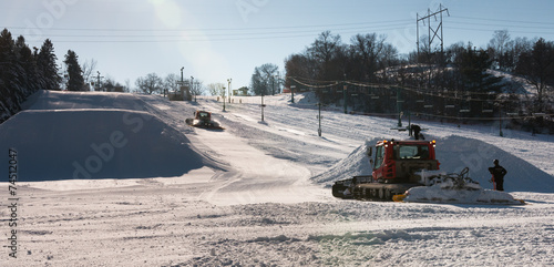 Schilderij op canvas Workers build terrain park at  ski field, Afton Alps, Minnesota,